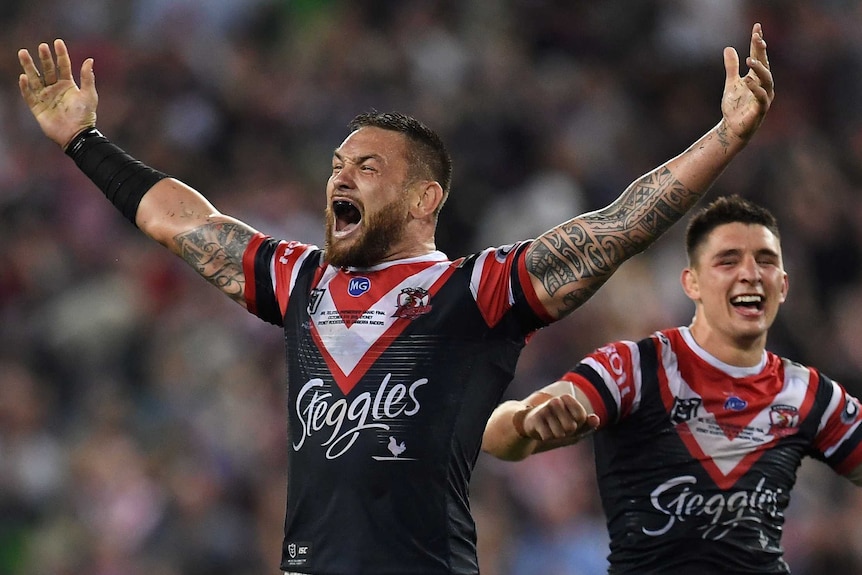 Roosters Jared Waerea-Hargreaves and Victor Radley shout and smile with their arms out after winning the 2019 NRL grand final.