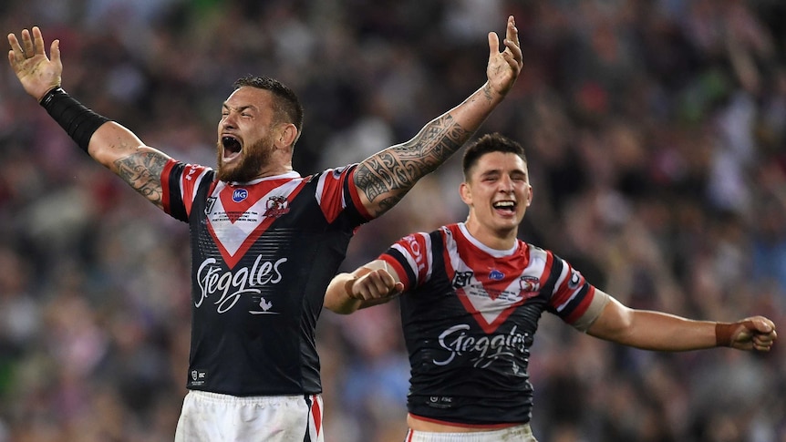 Roosters Jared Waerea-Hargreaves and Victor Radley shout and smile with their arms out after winning the 2019 NRL grand final.