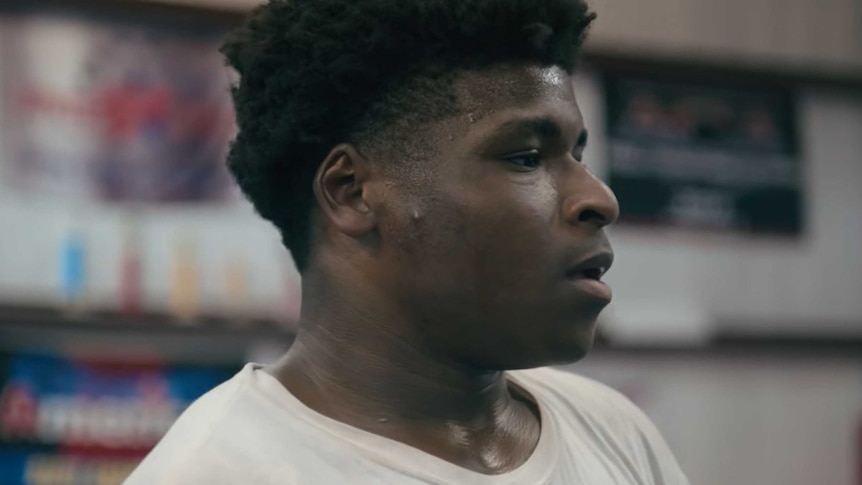 a close up side profile screenshot of Jerry Harris from the trailer to the Netflix series Cheer