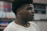 a close up side profile screenshot of Jerry Harris from the trailer to the Netflix series Cheer