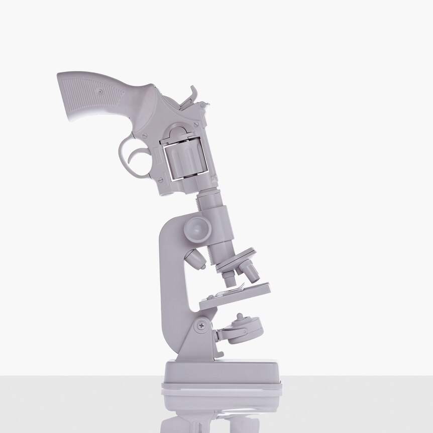 Art image featuring a white gun pointing down the eyepiece of white microscope lens