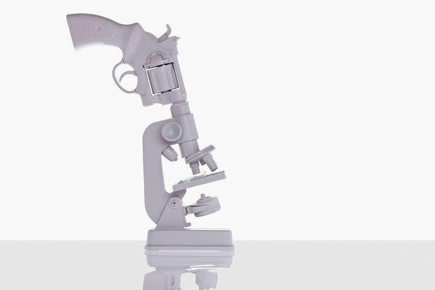 Art image featuring a white gun pointing down the eyepiece of white microscope lens