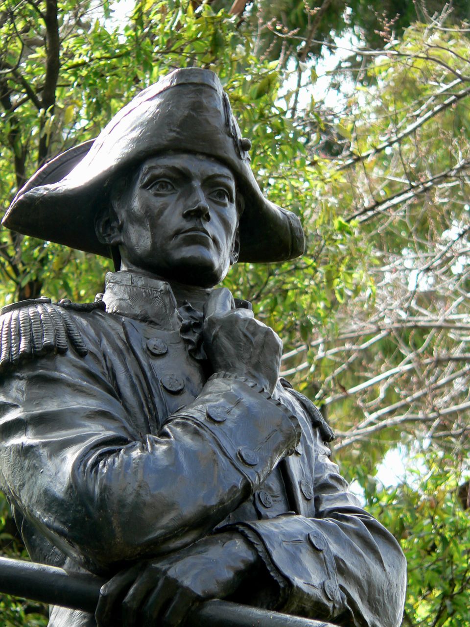 A statue of explorer Matthew Flinders, tree in background.