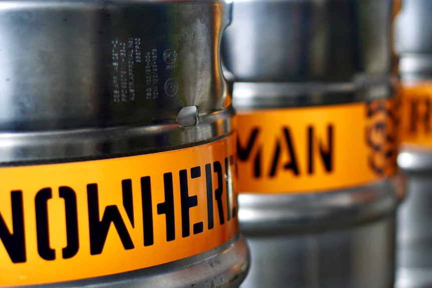 A close up of beer kegs with a Nowhereman logo.