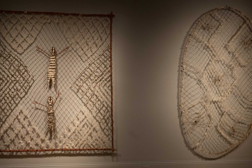 Australian Indigenous artworks hang in a gallery