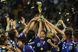 Japan’s players celebrate with the trophy after winning the FIFA Women's Football World Cup final.