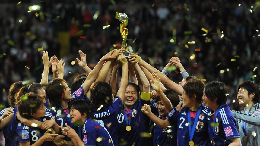 Japan’s players celebrate with the trophy after winning the FIFA Women's Football World Cup final.