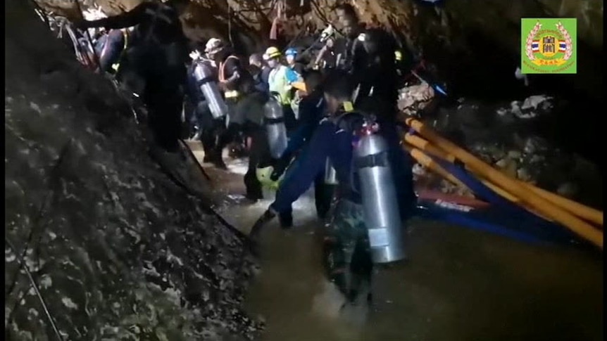Rescuers pump water and drill rock inside a cave where Thai boys are trapped