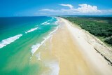 Aerial view of the blue water and white sand of the beach at Kawana on Queensland's Sunshine Coast