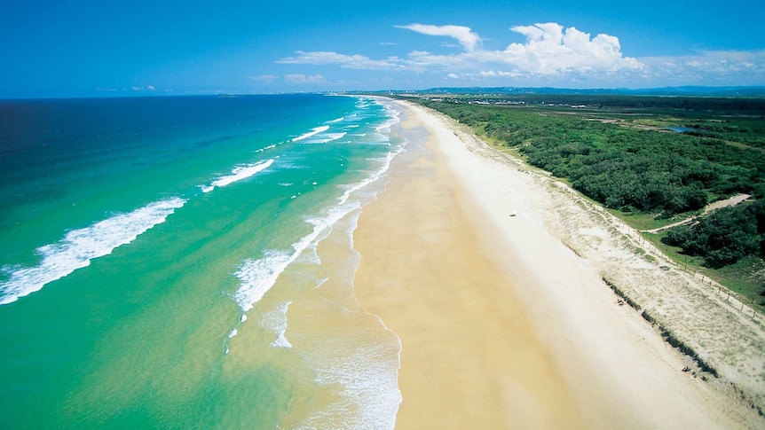 Aerial view of the blue water and white sand of the beach at Kawana on Queensland's sunshine coast