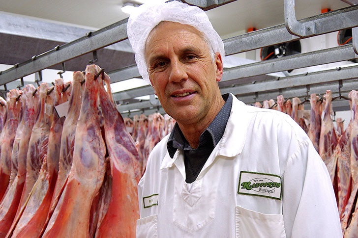 Rob Radford standing among carcasses of beef