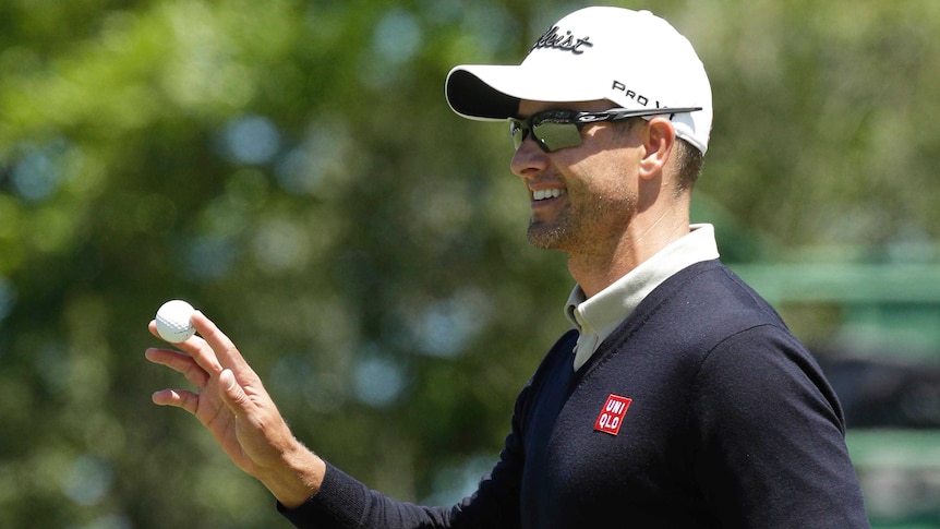 Australia's Adam Scott smiles after birdieing the first hole in the second round at the Masters.