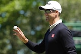 Australia's Adam Scott smiles after birdieing the first hole in the second round at the Masters.