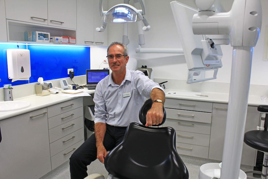 Dr Ralph Kelsey sitting in his Glenden dental practice