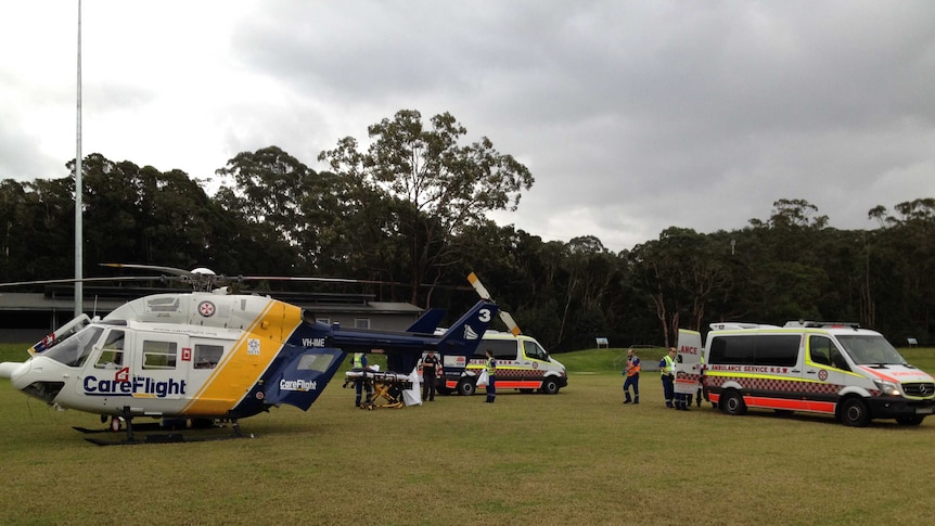 CareFlight helicopter with emergency service crews at Lisarow Oval