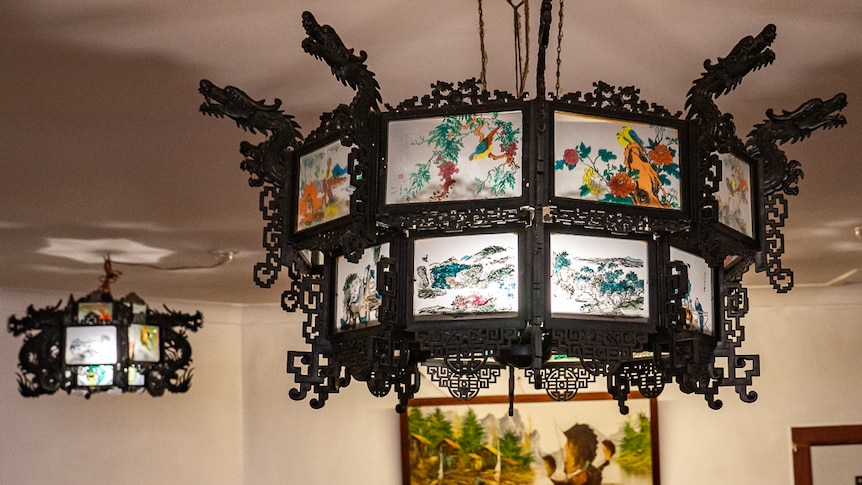 Chinese light shades hanging from ceiling of restaurant.