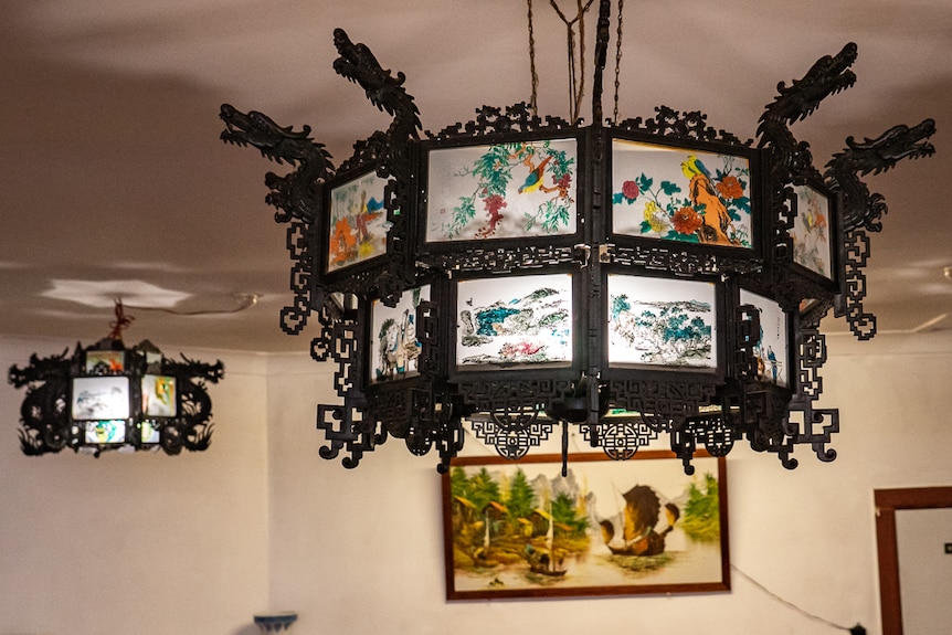 Chinese light shades hanging from ceiling of restaurant.