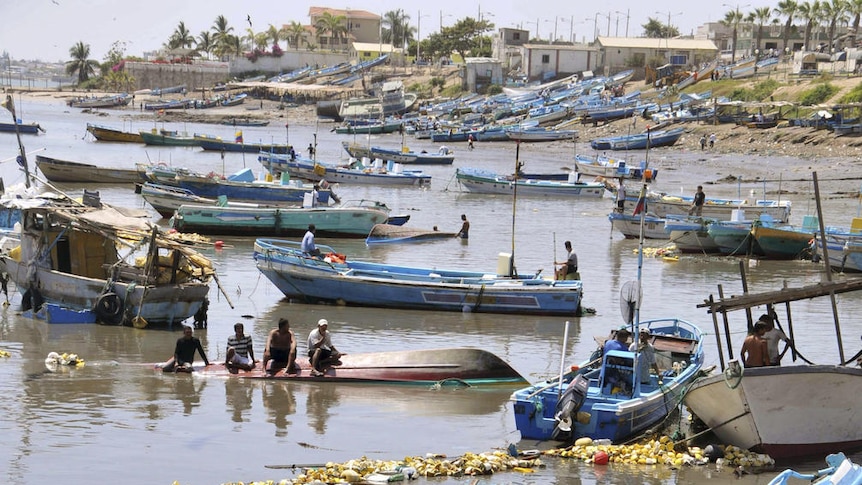 Boats damaged in the harbour after a tsunami hit Ecuador