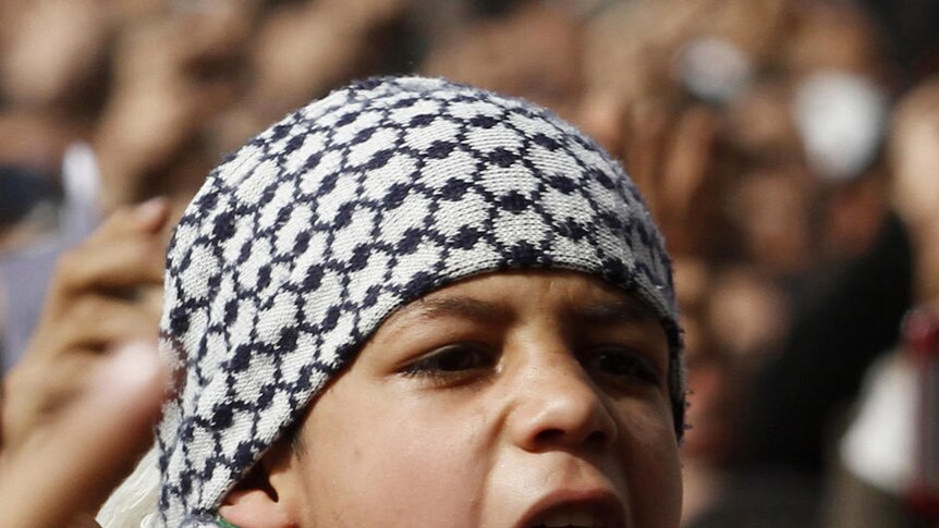 A boy shouts anti-Mubarak slogans after Friday prayers at Tahrir Square