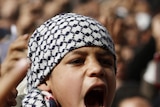 A boy shouts anti-Mubarak slogans after Friday prayers at Tahrir Square