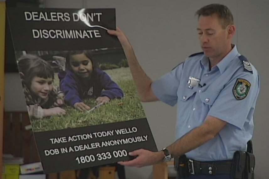 Senior Sergeant Simon Madgwick holds an anti-ice campaign poster.