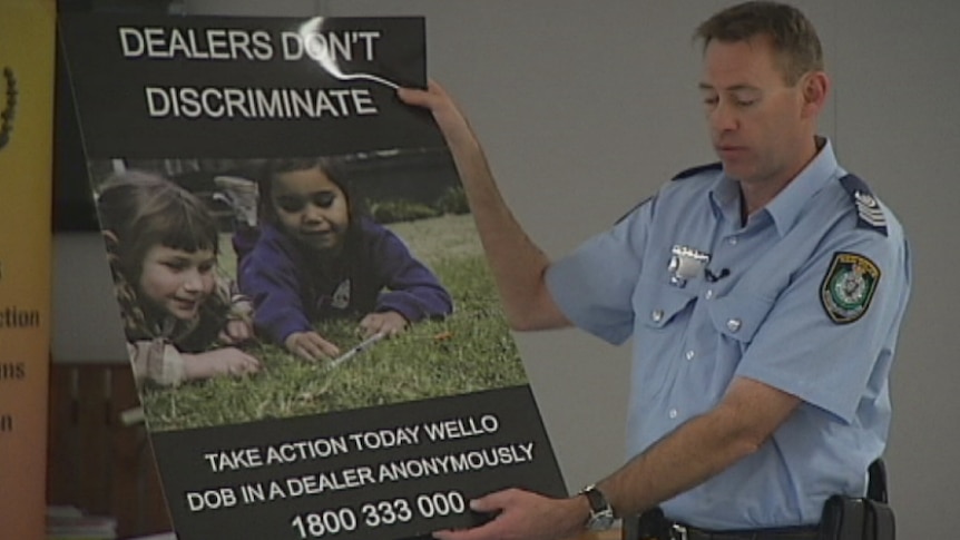 Senior Sergeant Simon Madgwick holds an anti-ice campaign poster.