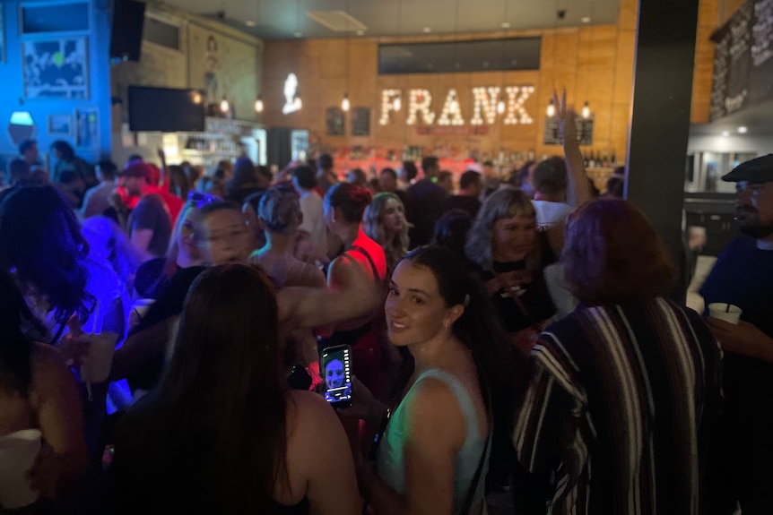 crowd in front of bar.