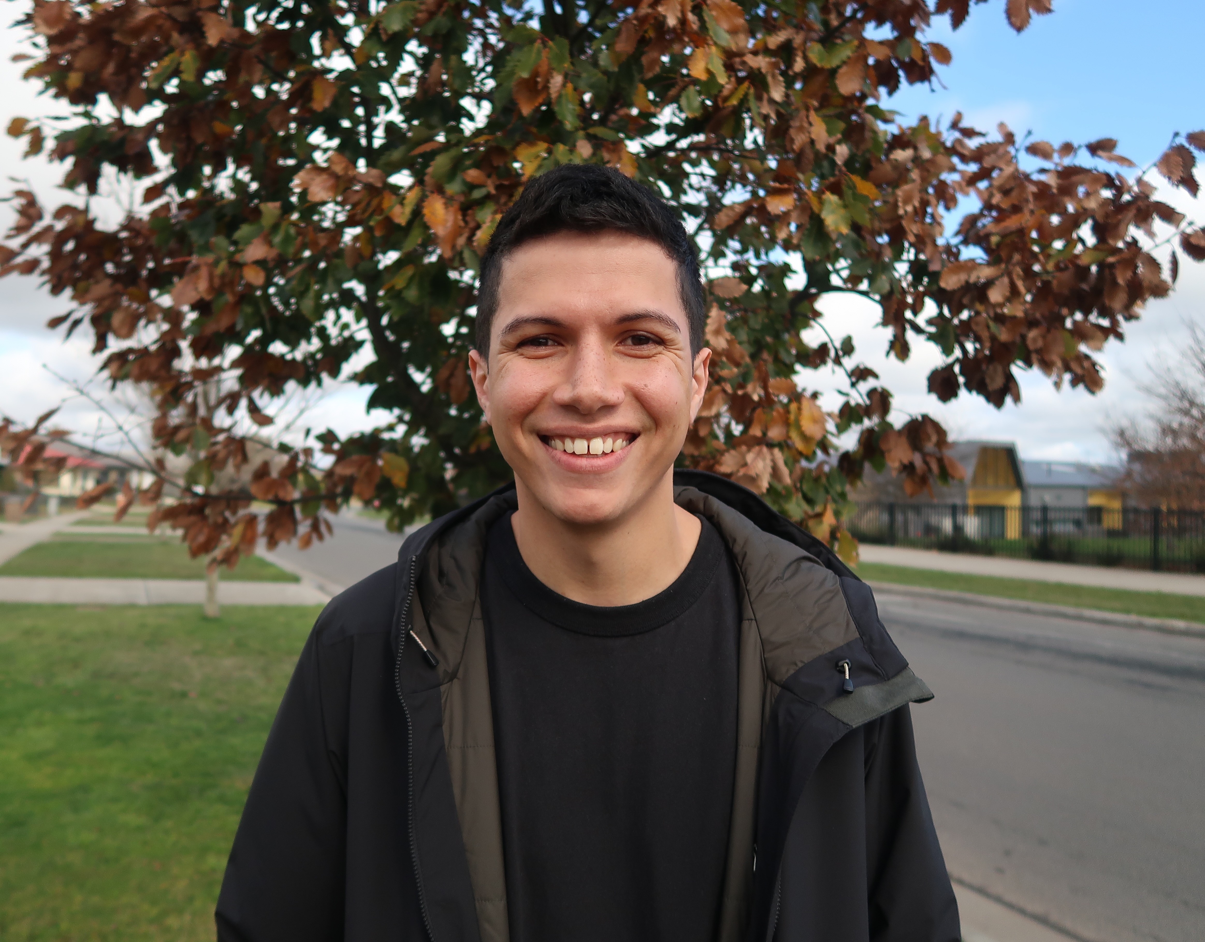 Close up shot of man smiling on side of the road