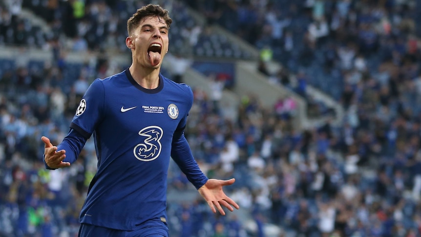 Man sticking his tongue out in celebration after scoring a goal during a soccer match