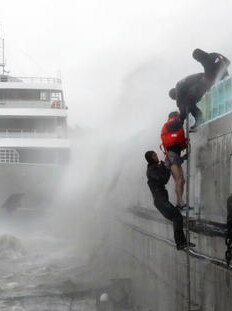 A crew member of a passenger boat stranded by Typhoon Chaba is rescued in Yeosu, South Korea.