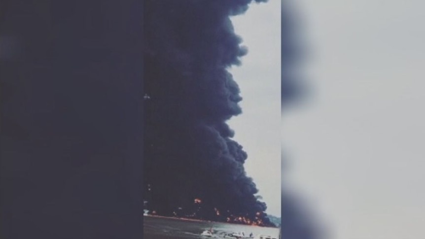Huge plumes of dark smoke emerge from oil slick fire off Borneo coast