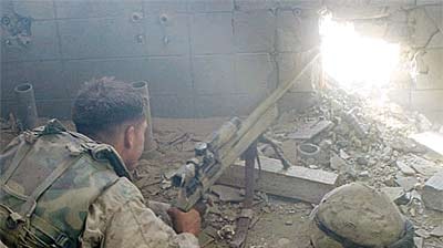 A US marine sniper looks out from a building in Fallujah.