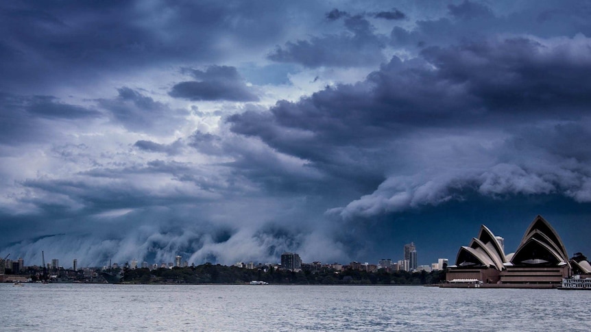 A shelf cloud rolls over Sydney, with the Sydney Opera House prominent in the foreground.