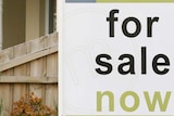 For sale sign outside house
