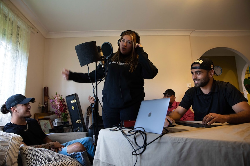 Young people making music in a living room.