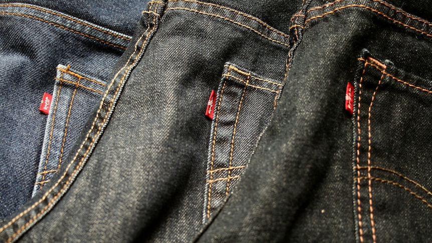 Three Levi's jeans with red tags lined up in a row