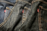 Three Levi's jeans with red tags lined up in a row