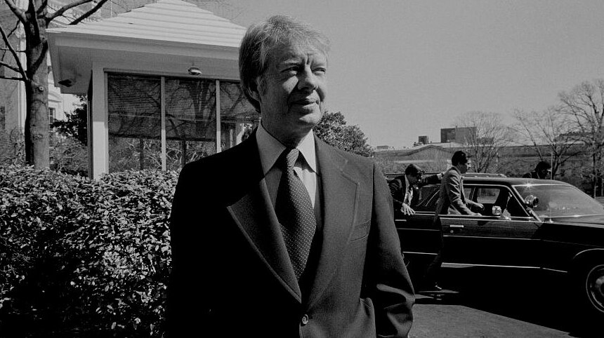 Jimmy Carter in a suit outside the White House