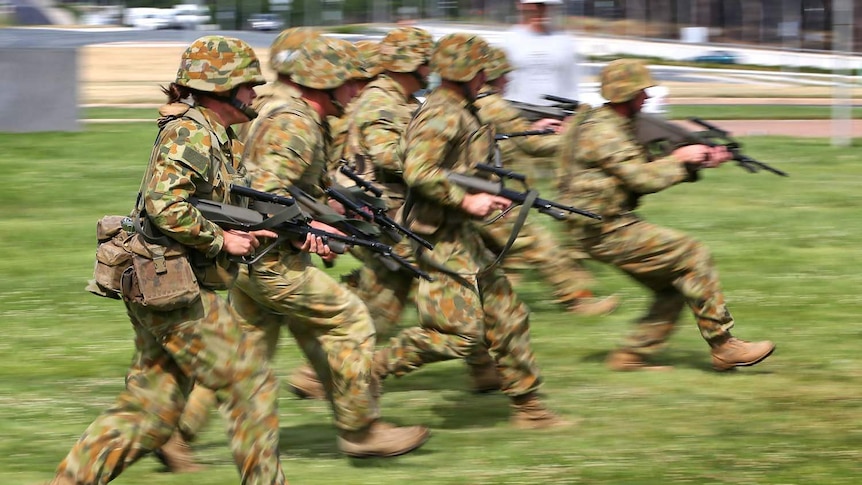 Australian soldiers run in a training exercise
