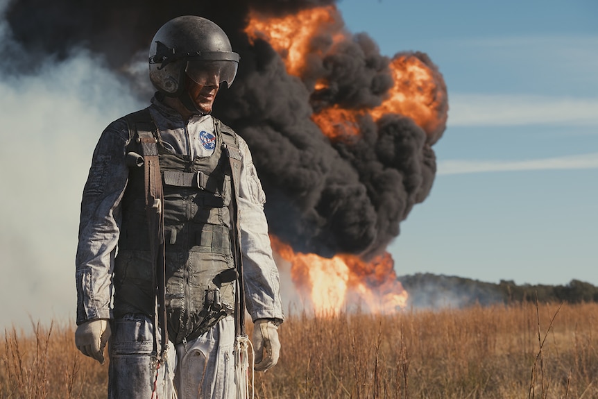 Ryan Gosling in front of explosion in First Man