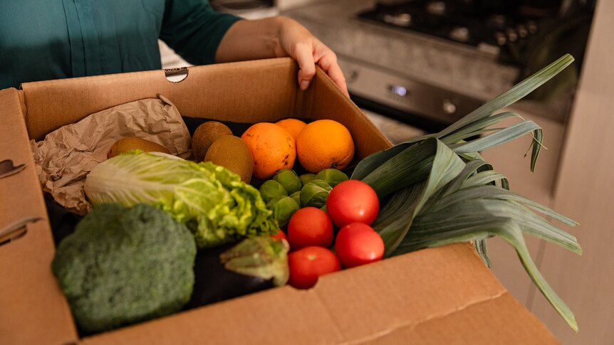 A box of fruit and veggies.