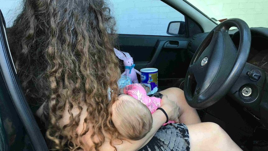 Woman with her baby in a car.