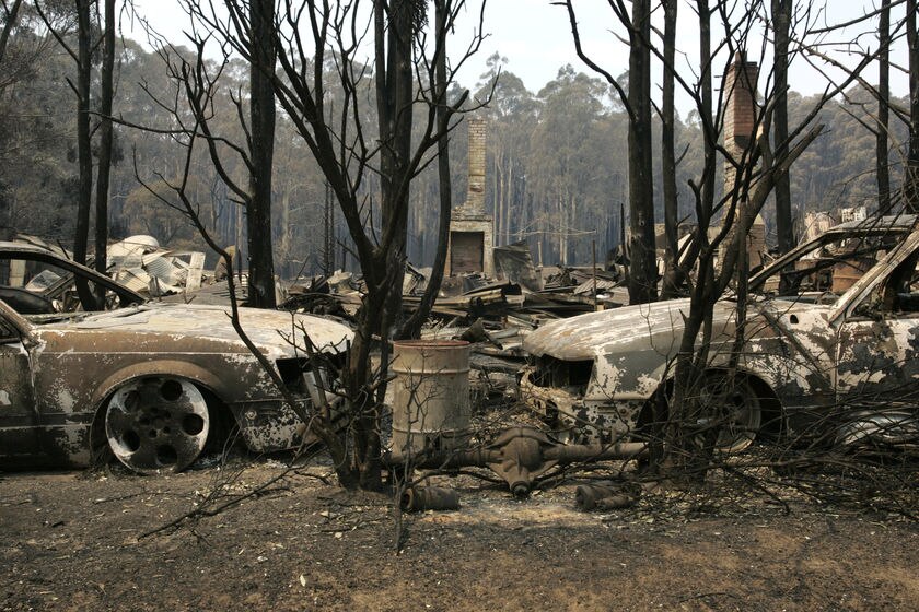 Destroyed cars in the ruins of a building in Narbethong after Black Saturday.