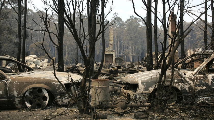 Destroyed cars in the ruins of a building in Narbethong after Black Saturday.