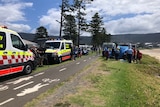 people standing around an ambulance 