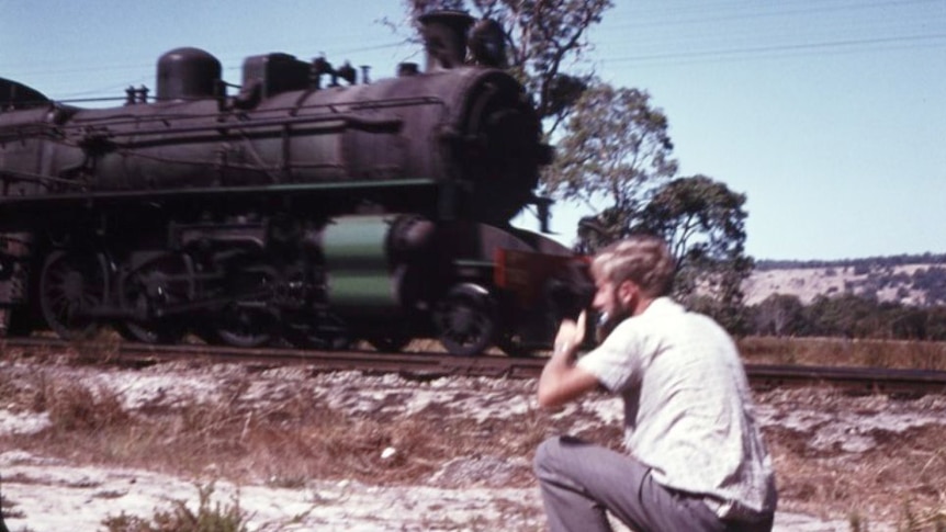 Weston taking a photo of a passing train