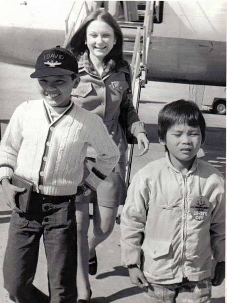 Two young boys disembark from a plane