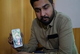 Manmeet Alisher's brother Amit, enroute to Brisbane, shows a photo of Manmeet on his phone.