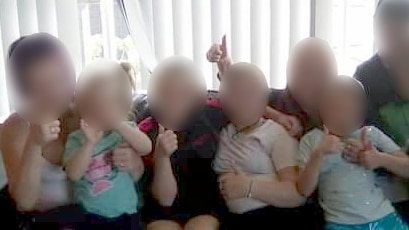 A group of children sitting on the couch.