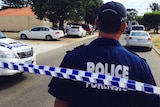 A police officer stands in front of police tape in Midland